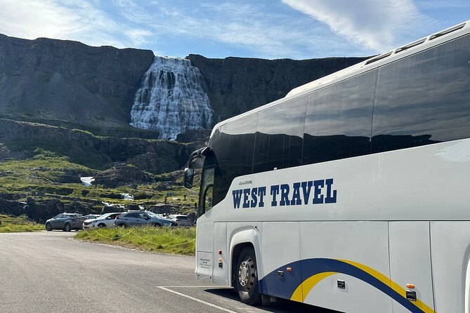 A tour coach parked below Dynjandi at the end of the access road