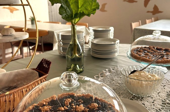 Coffee and cake laid out under glass domes in the Vigur farmhouse
